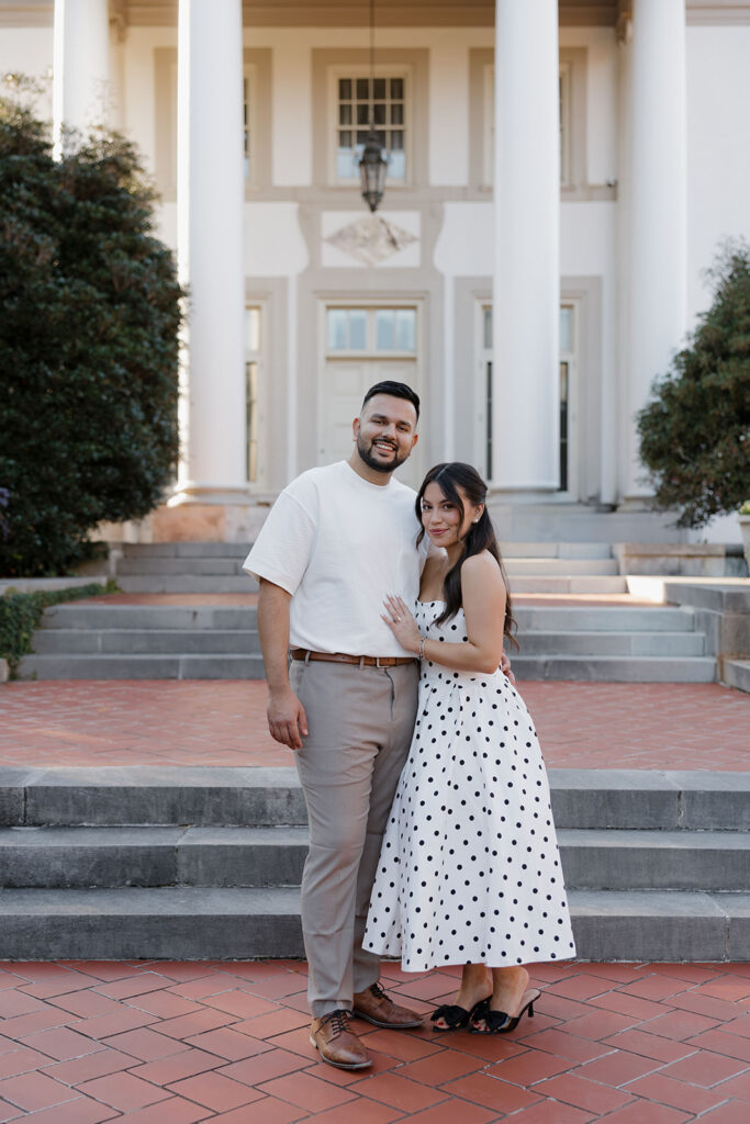 Couple posing in front of the historic estate columns at Hills & Dales Estate in LaGrange, GA