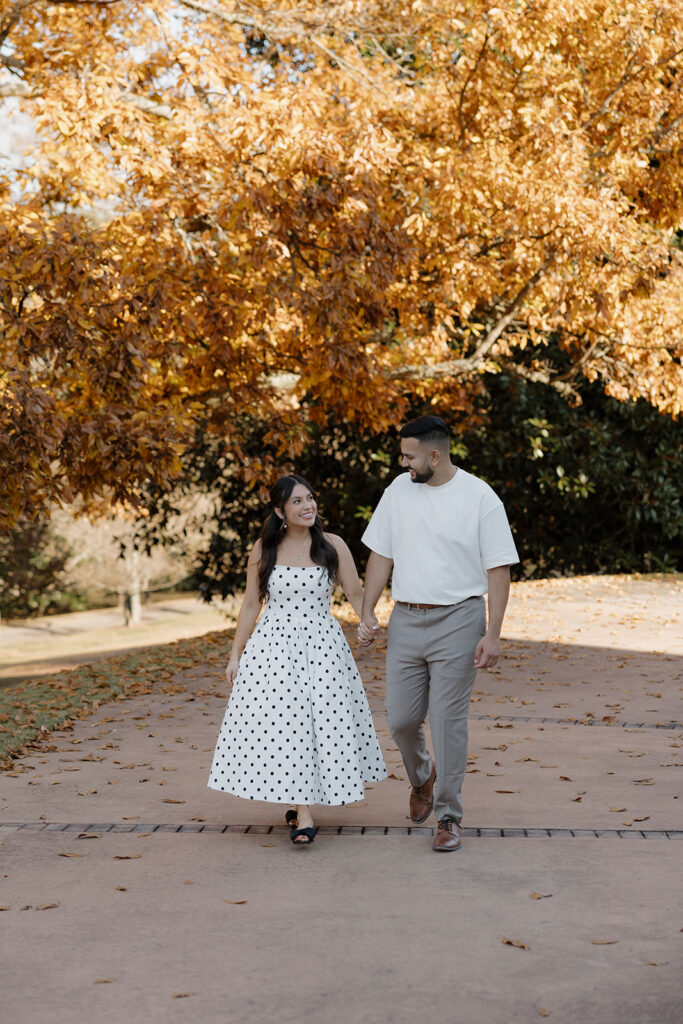 Couple laughing along paths at Hills & Dales Estate engagement session