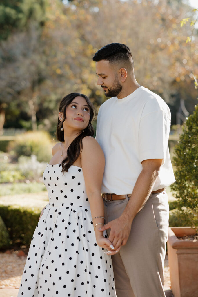 Engagement session on garden pathways with lush greenery at Hills & Dales Estate in LaGrange, GA