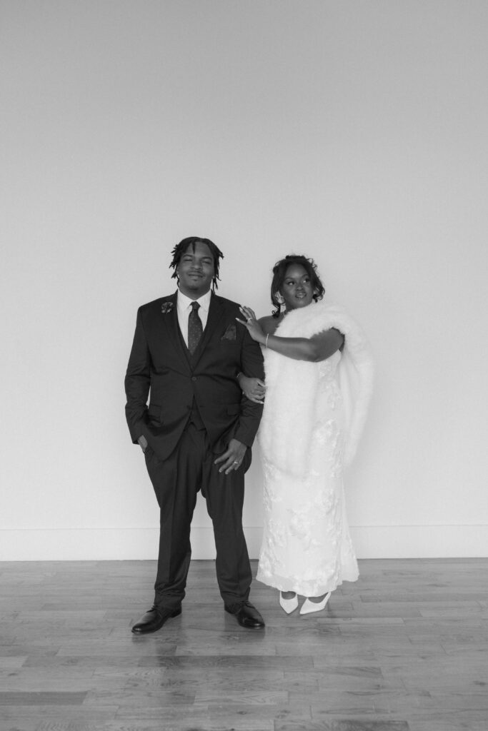 Studio wedding portraits of bride and groom in bright neutral studio space