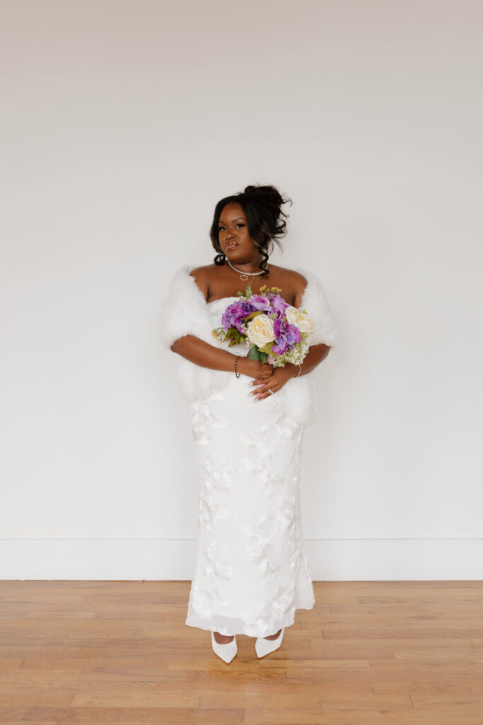 Bridal portraits in natural light studio with sleek wedding dress and shawl