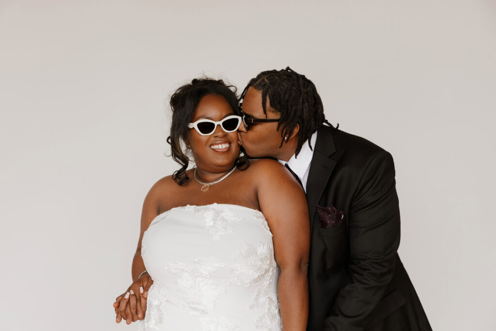 Studio wedding portraits of bride and groom in bright neutral studio space