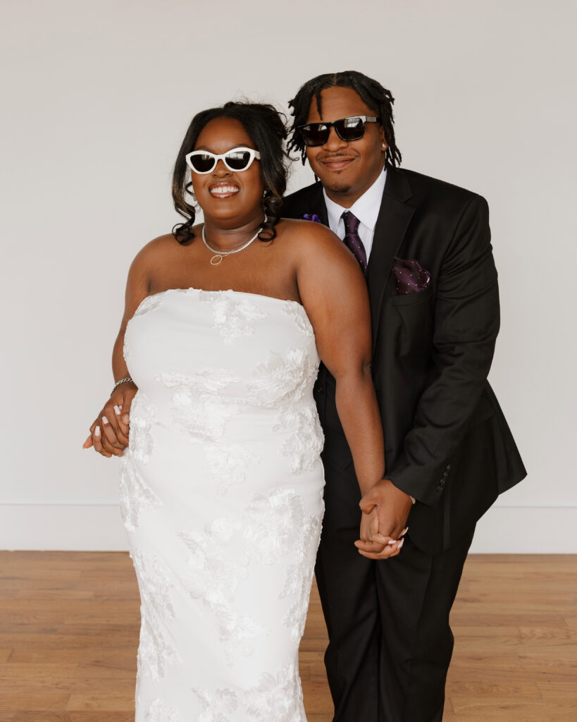 Studio wedding portraits of bride and groom in bright neutral studio space