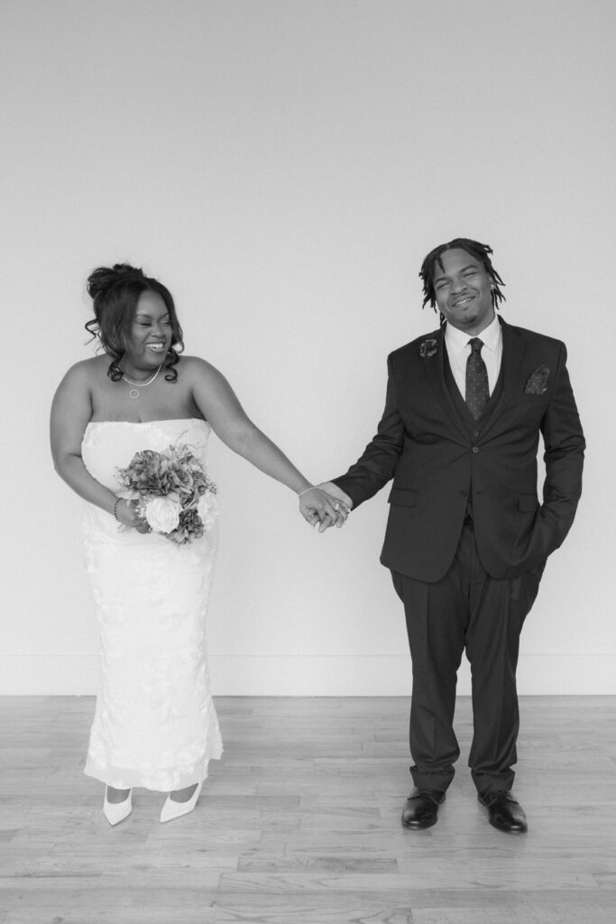 Studio wedding portraits of bride and groom in bright neutral studio space