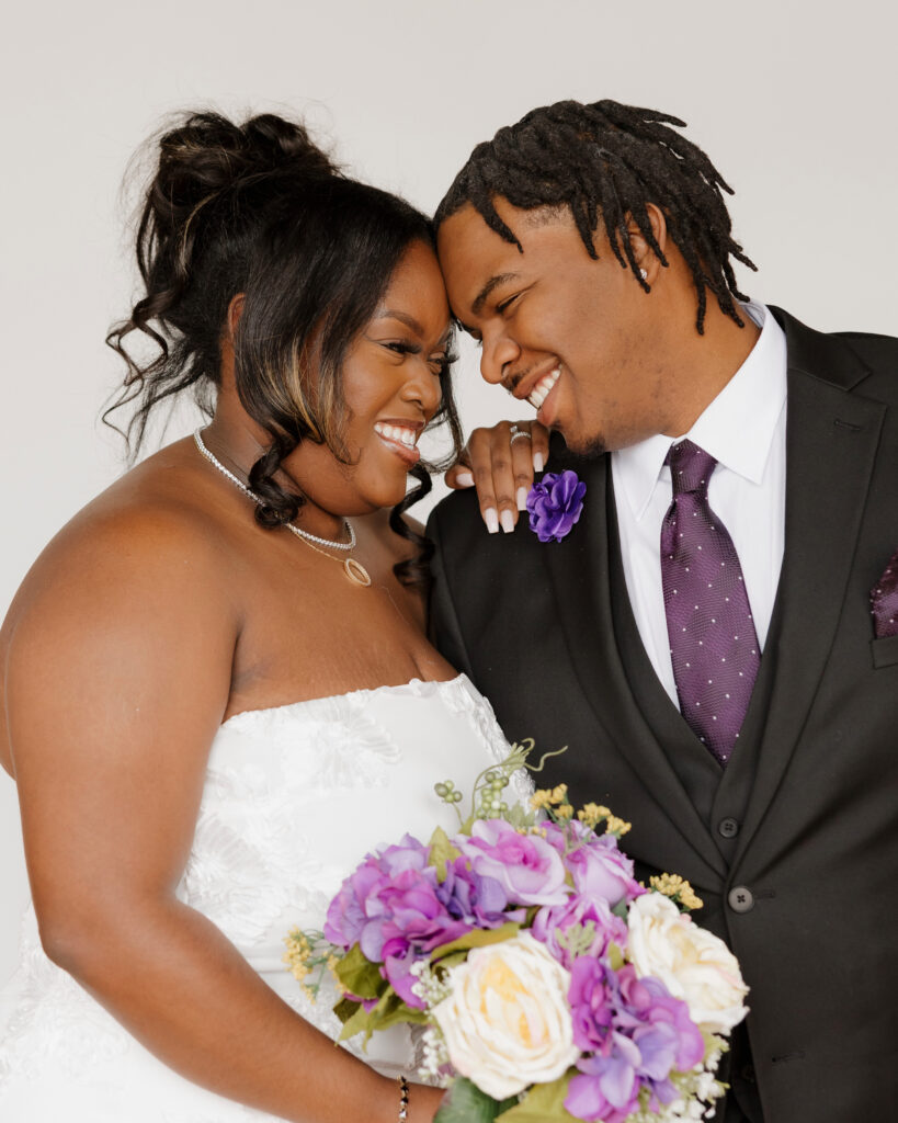 Studio wedding portraits of bride and groom in bright neutral studio space