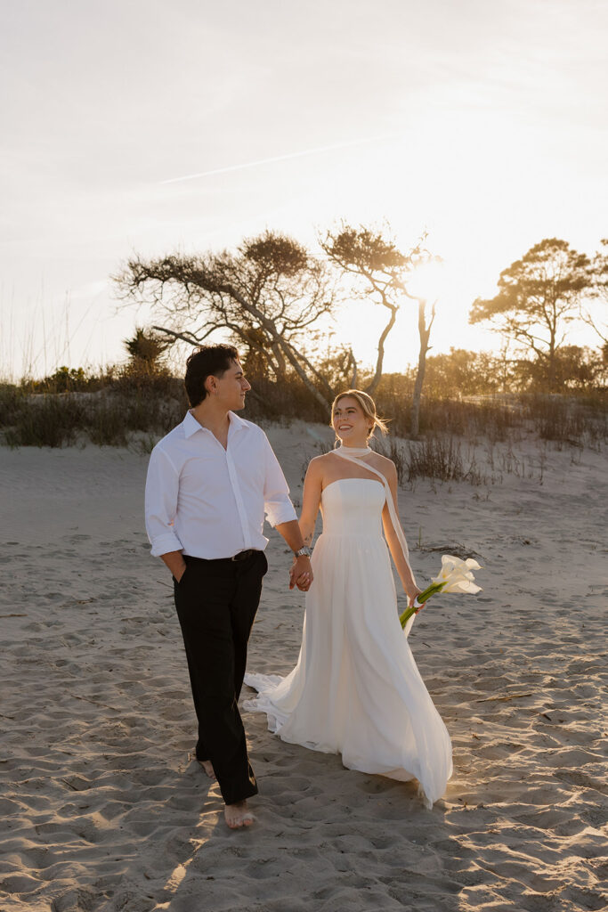 Folly Beach elopement photos at sunset with lighthouse by Leigha Gray Photography