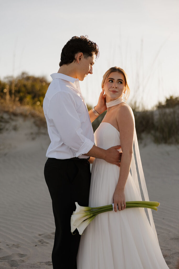 Folly Beach elopement photos at sunset with lighthouse by Leigha Gray Photography