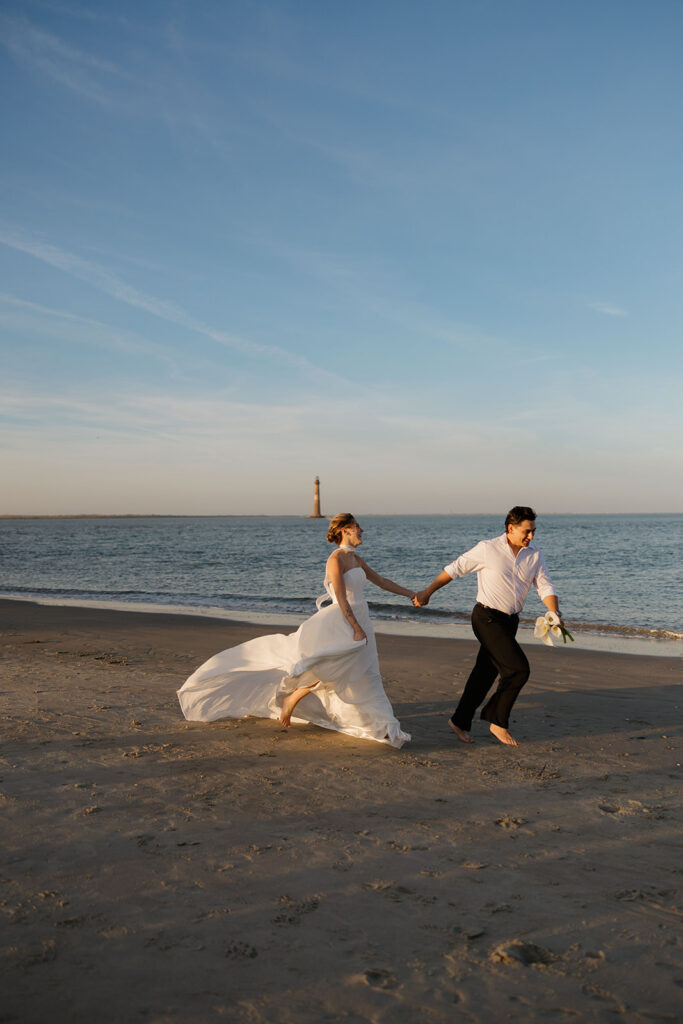 Folly Beach elopement photos at sunset with lighthouse by Leigha Gray Photography