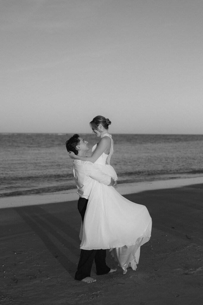 Folly Beach elopement photos at sunset with lighthouse by Leigha Gray Photography