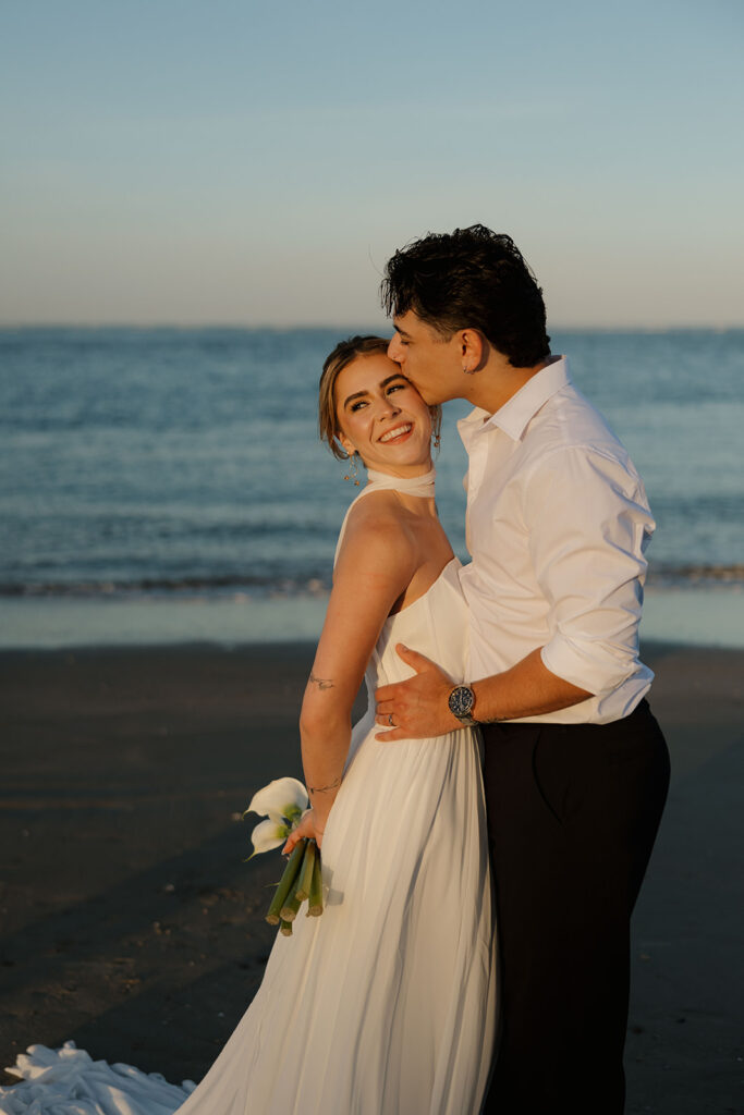 Folly Beach elopement photos at sunset with lighthouse by Leigha Gray Photography